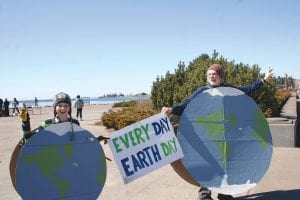 Just to let the people driving or walking by know that there was an Earth Day celebration going on in Harbor Park, Denny FitzPatrick and Naomi Tracy-Hegg dressed up in worldly costumes and waved at the passersby. Naomi is a member of the Nordic Nature Group who helped to sponsor and organize harbor cleanup. Events began at 10 a.m. with a harbor beach cleanup and continued through the day with a march for science and speeches that followed, a lecture at Voyageur Brewing with geologist Dr. Green began at 5 p.m. and a 7 p.m. film titled “A Plastic Ocean” about the giant plastic mess floating in the middle of the Pacific Ocean that was shown at the library with about 30 people attending concluded the day.