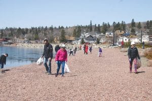 In celebration of Earth Day – one day early – more than 50 people turned out to help pick up litter and trash on the Grand Marais harbor beach on Saturday, April 21. All told, about 157 pounds of refuse came off the beach and surrounding area.