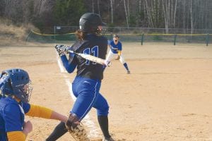 Left: Wearing jersey No. 11, Abbie Crawford smacked a ground ball against the Esko Eskimos. Above: Her bat ready to swing, Katie Peck keeps a keen eye on the ball coming her way.