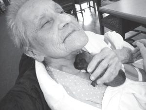 The residents are happy to welcome all kinds of visitors! Pictured here is Audrey Pollock cuddling with a 2-week-old puppy.