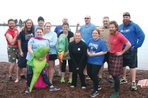 More than a dozen teachers and community members took part in the Nordic Dunk held Wednesday, May 9 to raise money for the school’s Special Olympics program. While the goal was to raise $250 through pledges made to each dunker, the team actually raised over $400. Smiling before they hit the frigid waters of Lake Superior are, from L-R starting in front: Melissa Oberg, MaeAnna LaFavor, Marlene Wester, Lena Santos and Jay Arrowsmith DeCoux. Back row L-R: Kris Hoffman, Tom Sullivan, Mike McHugh, Chad Benesh, Megan Rubbalke, Mitch Dorr, Pat Eliasen and Peter Lucken.