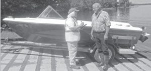 An inspector goes over procedures with a boater to make sure the boat is free of invasive species. Inspectors will be at various locations this summer making sure boaters follow the protocol set by the state in an effort to stop the spread of invasive species.