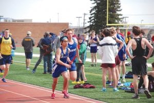 Trent Spry watches as JRon Tamanaha speeds down the track with the baton in his firm grip. If a runner drops the baton, he must return and pick it up to continue in the relay race.