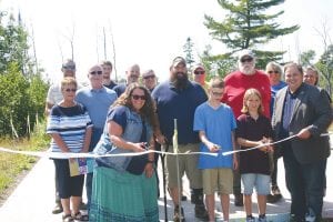 Last fall the Theo Rex family from Buffalo, Minnesota was at the building site of their new home in Hovland. While they hoped to be in it before fall ended, some delays pushed back the project. The house is now almost complete and was built because of the efforts of Journey Home, an organization located in North Oaks, Minnesota, to aid wounded veterans. Theo served 15 years in the Army, leaving the service in 2014 as a disabled veteran. Cutting the ribbon on the site of their home last summer were Jamie (mom), Hunter and Ben, with their dad, Theo standing between Jamie and Hunter.