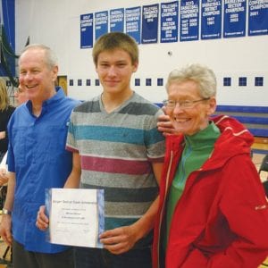 Nick and Carol Burger flank a gracious and happy Mike Burton after presenting Mike with the new Burger Scholarship for $1,000. The award was based mostly on being a good kid, helpful and kind to everyone he meets.