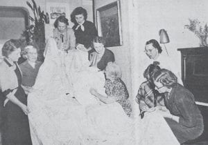 An autographed tablecloth, started by the Priscilla Circle of the Bethlehem Lutheran Ladies in 1951, was completed in March 1974 as part of the celebration of the church’s 75th anniversary. Shown completing the project, from left, are Mrs. Harold Phillips, Mrs. Lester Rasmussen, Mrs. Roger Scott, Mrs. Ralph Jackson, Mrs. Harry Johnson, Mrs. Olaf Moen, Mrs. David Lind, Mrs. Ade Toftey and Mrs. Iver Bentley. The tablecloth is comprised of 36 large linen squares embroidered with the signatures of all pastors and their families who have served the Grand Marais church. Plans are to use the cloth for spring and anniversary functions.