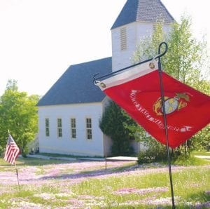 American flags and flowers decorate the graves of veterans at the Maple Hill church and cemetery.