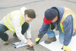 Maren Webb and Rich Furlong work on the Safe Routes to School Demonstration Project at the intersection of County Road 7 and First Avenue West in front of Cook County Schools. On May 30, the SRTS Committee, including Cook County Schools, the City of Grand Marais, Cook County Highway Department, and the Sawtooth Mountain Clinic, started the installation of a temporary crosswalk.