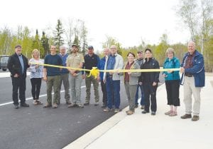 Bruce Martinson, wearing a white coat and glasses in the middle, took part in the Gitchi Gami trail ribbon-cutting ceremony. Ginny Storlie is second to the end on the right.