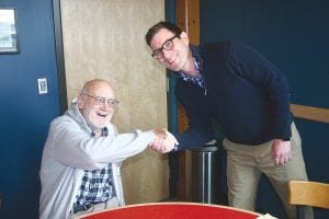 Jason Metsa shakes hands with Lawrence Landherr at a gathering held at the Cook County Whole Foods Co-op where Metsa, who is running for Congress in the 8th District, listened to the concerns of local people.