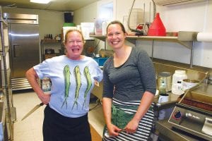 Anna Hamilton (L) and Kate Keeble were busy working in the kitchen at Hughie’s Taco House last Thursday. Kate and her husband Jeremy recently purchased Hughie’s from Anna and the business will be renamed Hungry Hippie Taco House. The Keebles also own and operate the Hungry Hippie Hostel. Anna owned and operated Hughie’s Taco House for almost 10 years. Before that she and her sister Sarah started and ran My Sister’s Place and she and Sarah currently own Trail Center Lodge and Restaurant.