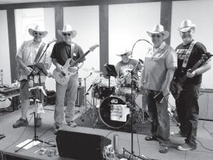 On the left, Cook County Sheriff Pat Eliasen, on lead guitar and vocals, got together with Troy Dunn, Rice County sheriff (percussion and vocals), Rick Fiedler, Wilkin County sheriff (rhythm guitar and vocals), Scott McNurlin, Goodhue County sheriff (drums) and Scott Rose, Dodge County sheriff (bass guitar) to form a band that performed in Brainerd and raised $2,502 for the Law Enforcement Torch Run for Special Olympics.