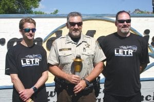 At Java Moose Sherriff Pat Eliasen posed with the Flame of Hope torch while being flanked by deputy Will Sandstrom and Dave Lane, on Pat’s left. For the second year in a row Thunder Bay, Ontario police carried the torch to the Pigeon River border crossing and after a short ceremony, passed the torch to Cook County law enforcement.