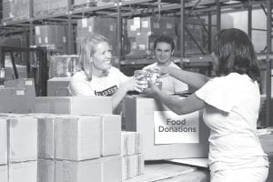 Volunteers working at a food shelf are obviously enjoying their “labor of love.” The local food shelf is in need of help. If you have any free time and like to help your fellow citizens, please volunteer for the food shelf.