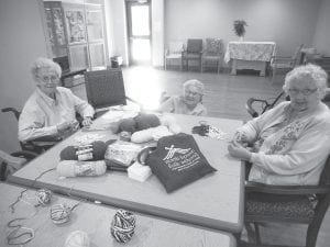 Mary Liebsch, Bernice Legarde, and Joyce Hagen are pictured here preparing a craft project for kids at North House Folk School.