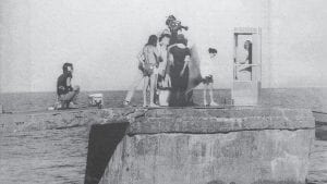 Who has a dime? A film crew placed a telephone booth on the old dock at the Edgewater in Tofte. About 15 minutes of a 90-minute feature film “Our House” was shot in the Tofte area August 18-22, 1983 by an eclectic group of filmmakers who described the film as “surrealistic,” which explains the position of the phone booth, which was brought from the Twin Cities for the project.