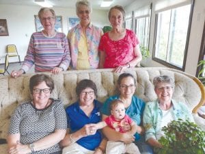 The flower show committee is all smiles about this year’s flower show. Front row L-R: Renee Larsen, Marcia Latz, Monica Anderson with her baby Alma, and Gwen Lenz. Back row L-R: Emma Bradley, Nancy Strayer and Philis Anderson. Missing from photo is Gwendolyn Neumann. Gwendolyn is co-chair of the flower show committee, but couldn’t attend the meeting.