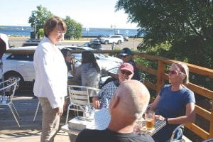 U.S. Senator Amy Klobuchar (DFL) met with business leaders in Grand Marais at the Voyageur Brewing Company. After the meeting Klobuchar chatted with guests on the deck and had quite a few pictures taken with people.